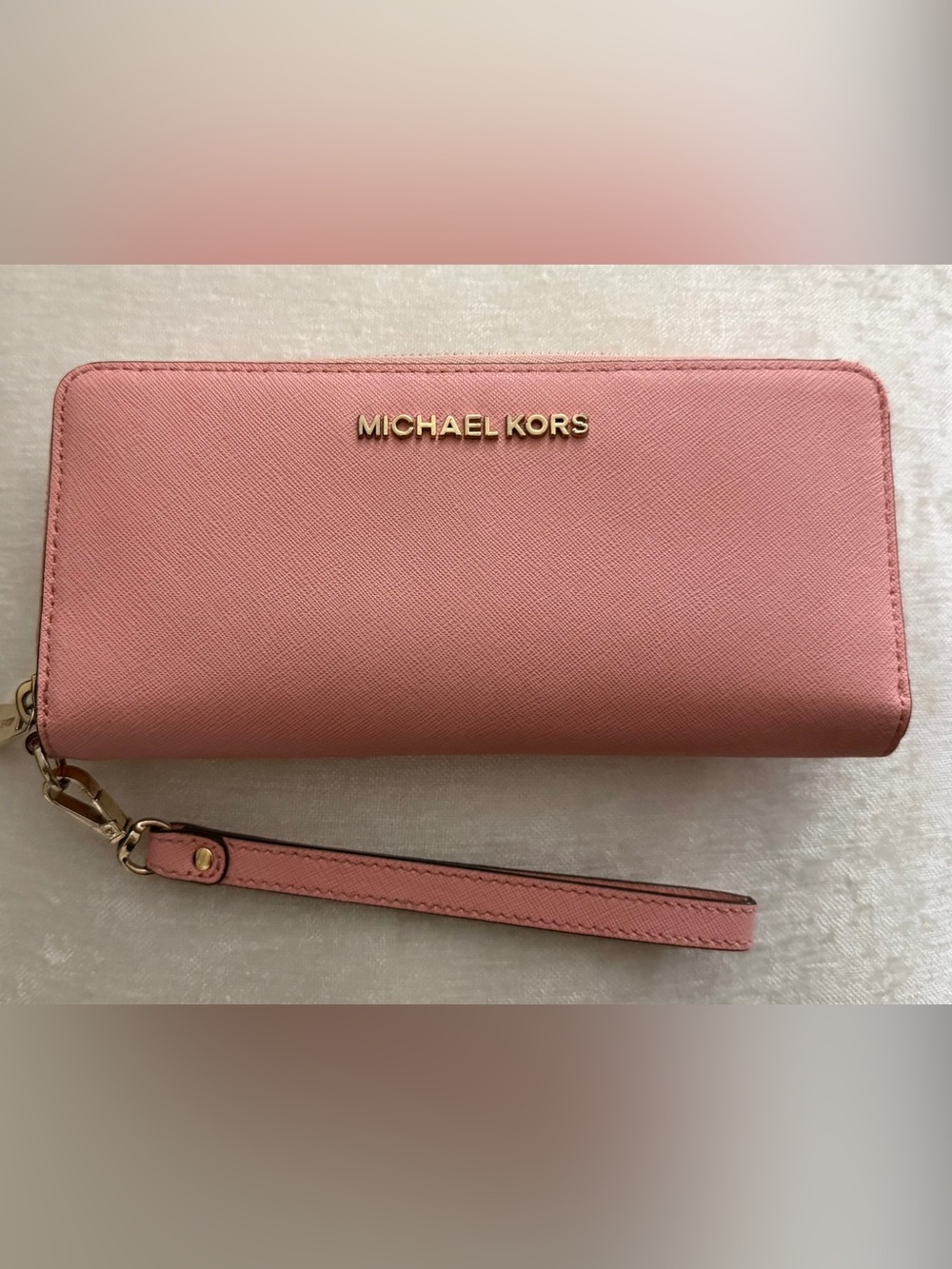 Authentic Michael Kors light to medium pink large clutch wallet.